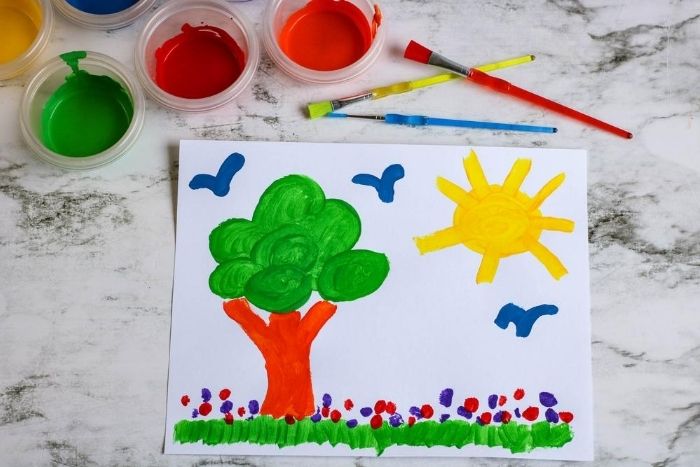 kids painting of a tree, birds, and the sun