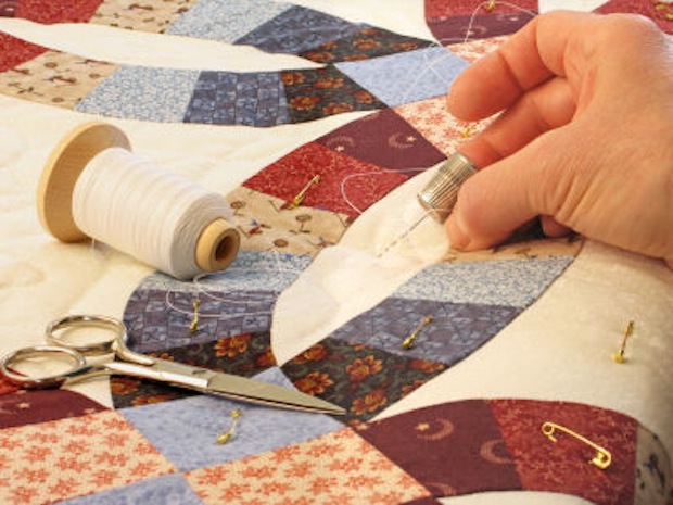a person working on a quilt