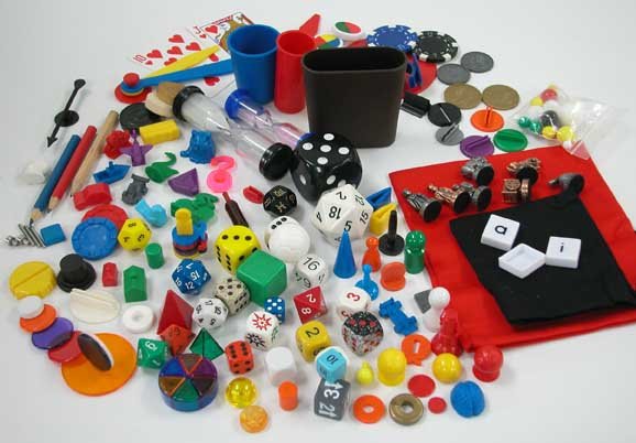 pile of dice and various board game pieces