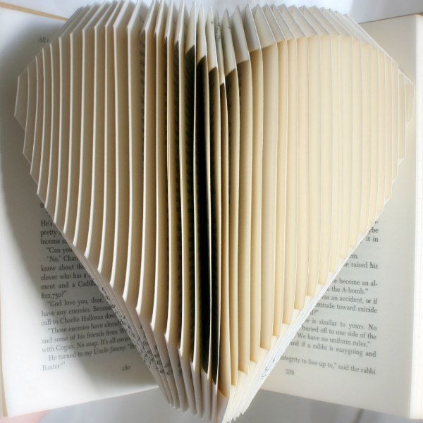 book with pages folded to create a heart shape
