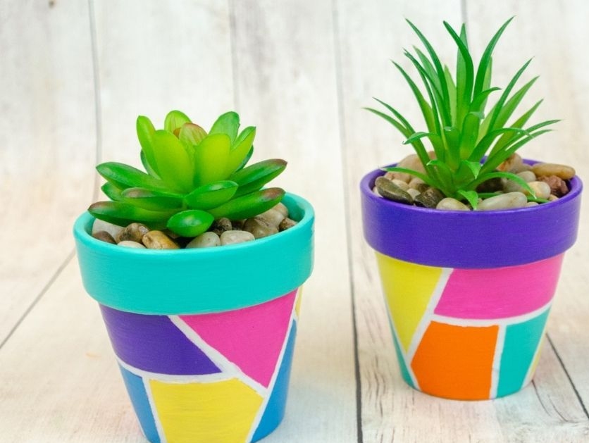 flower pots painted with colorful geometric shapes