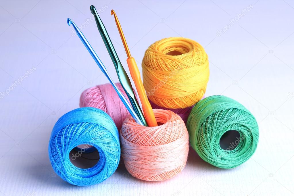 5 colorful skeins of yarn and 3 crochet hooks