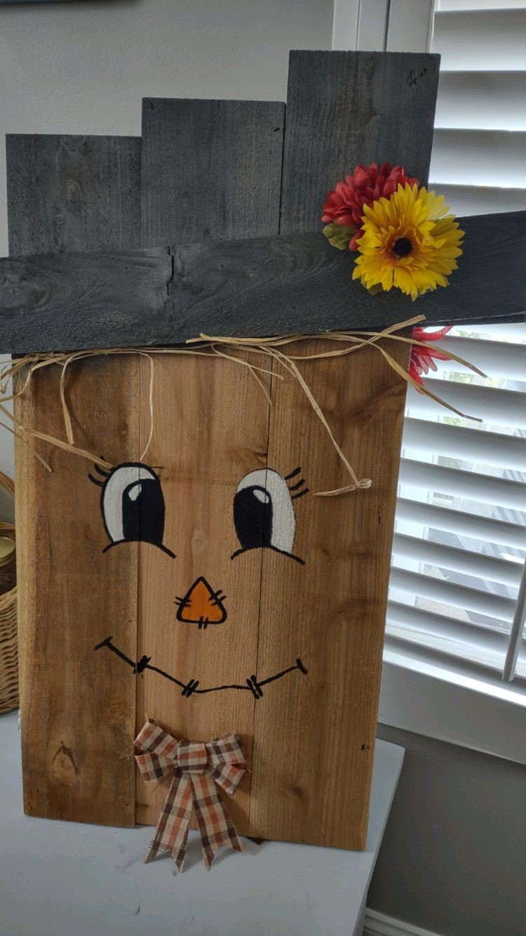 boards painted to look like a scarecrow