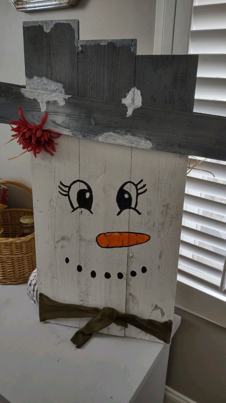 boards painted to look like a snowman