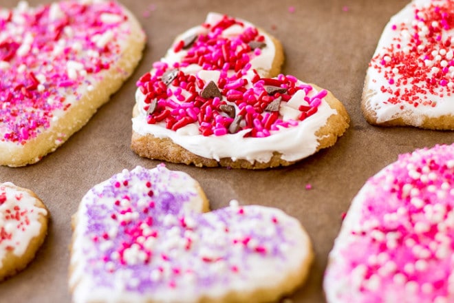 heart shaped cookies with frosting and sprinkles