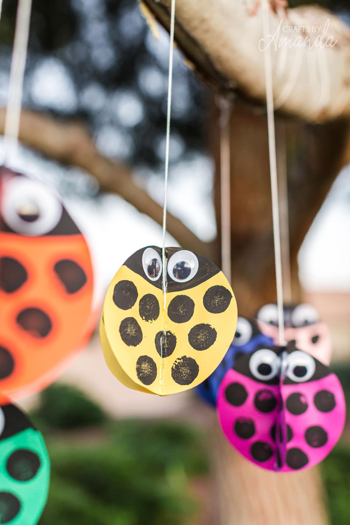 a hanging mobile of paper ladybugs