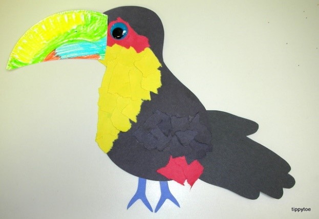 a toucan craft made with construction paper and a paper plate