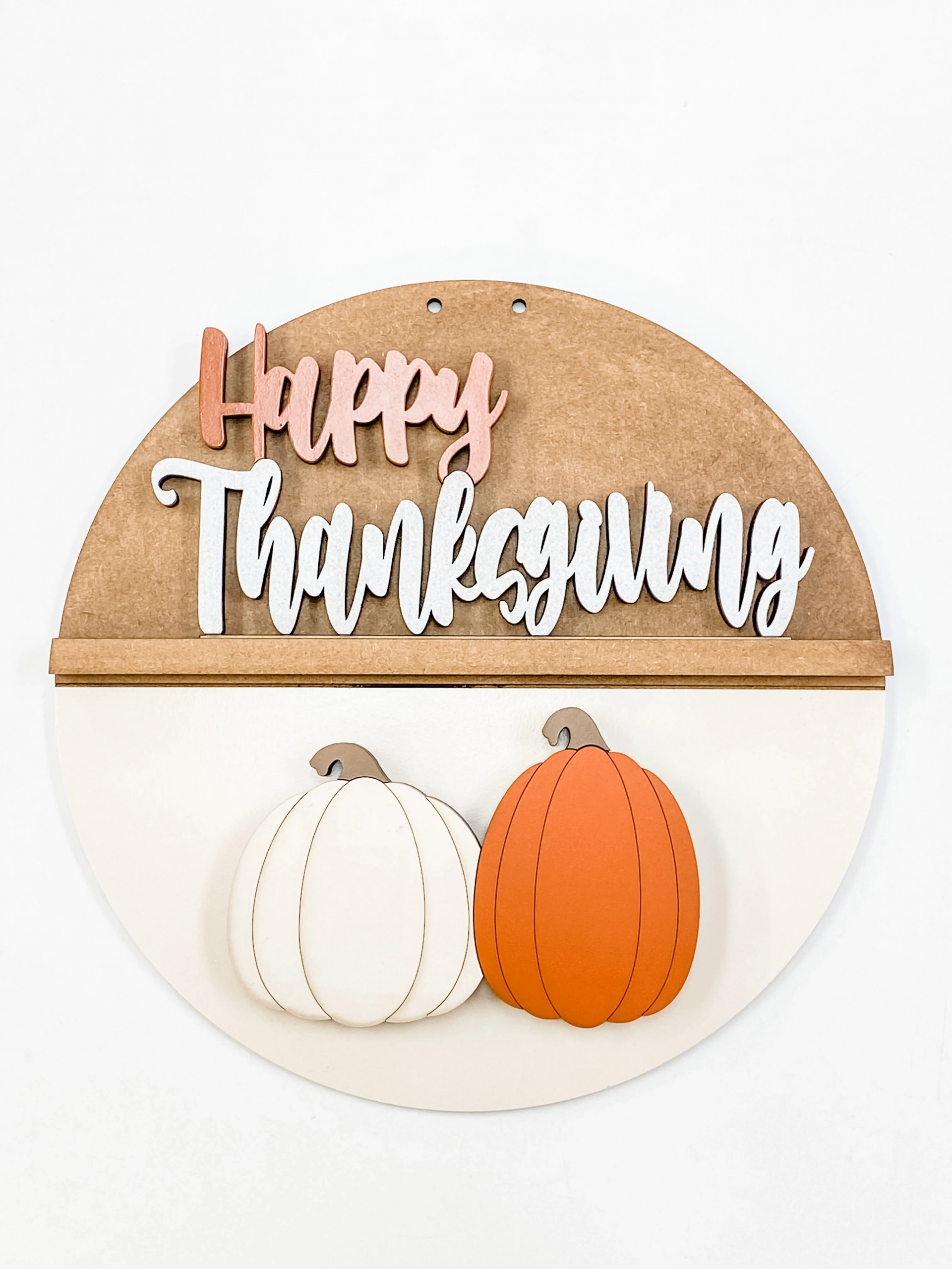 wooden sign with 2 pumpkins, says happy thanksgiving