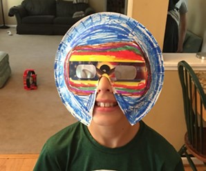 solar eclipse mask made with solar eclipse glasses and a paper plate colored with markers