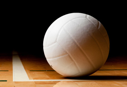 a volleyball on the corner of a volleyball court
