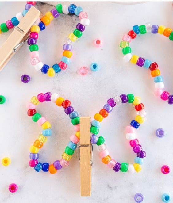 butterfly craft made with beads and clothespins