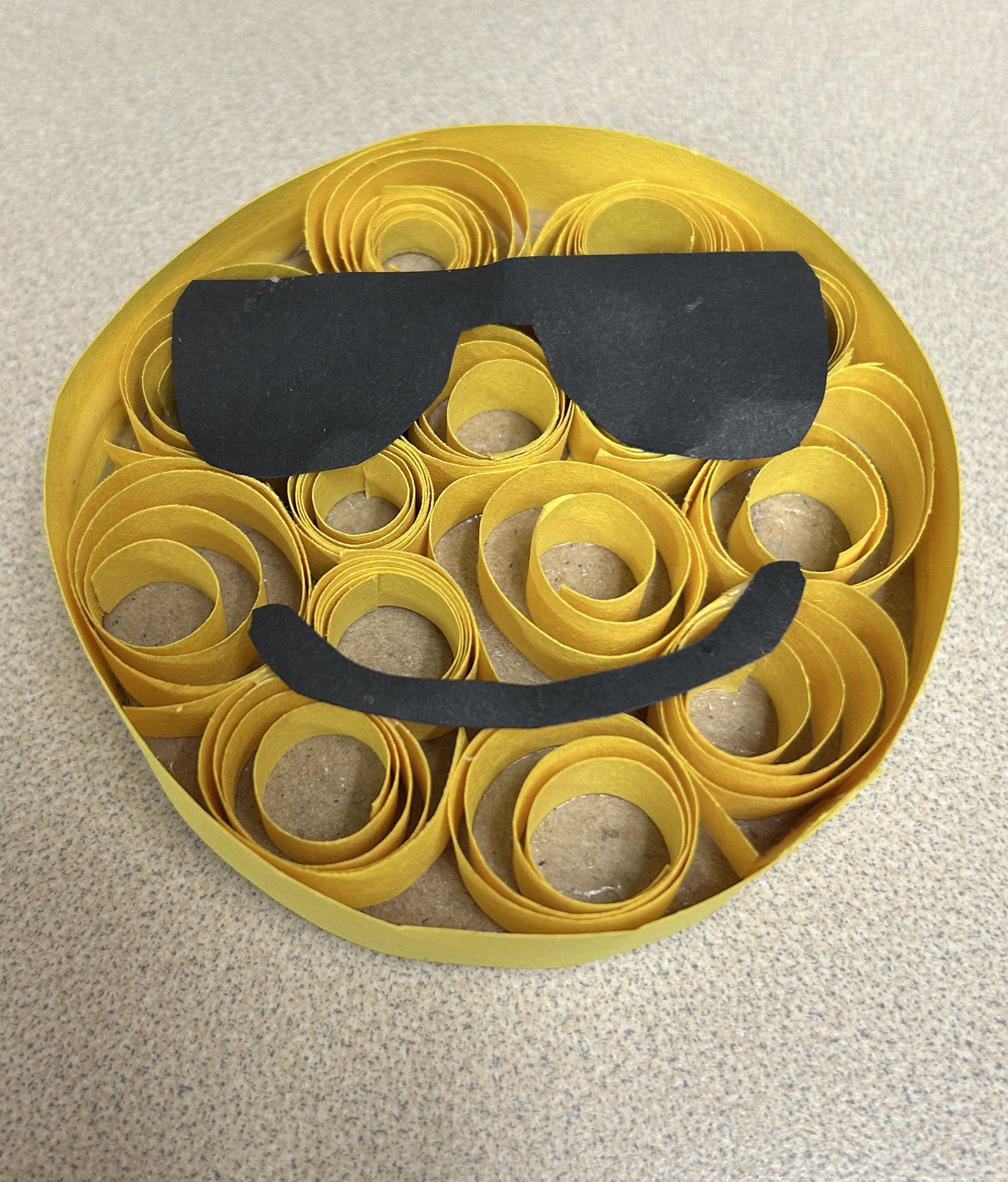 smiley face with sunglasses made using curled paper pieces