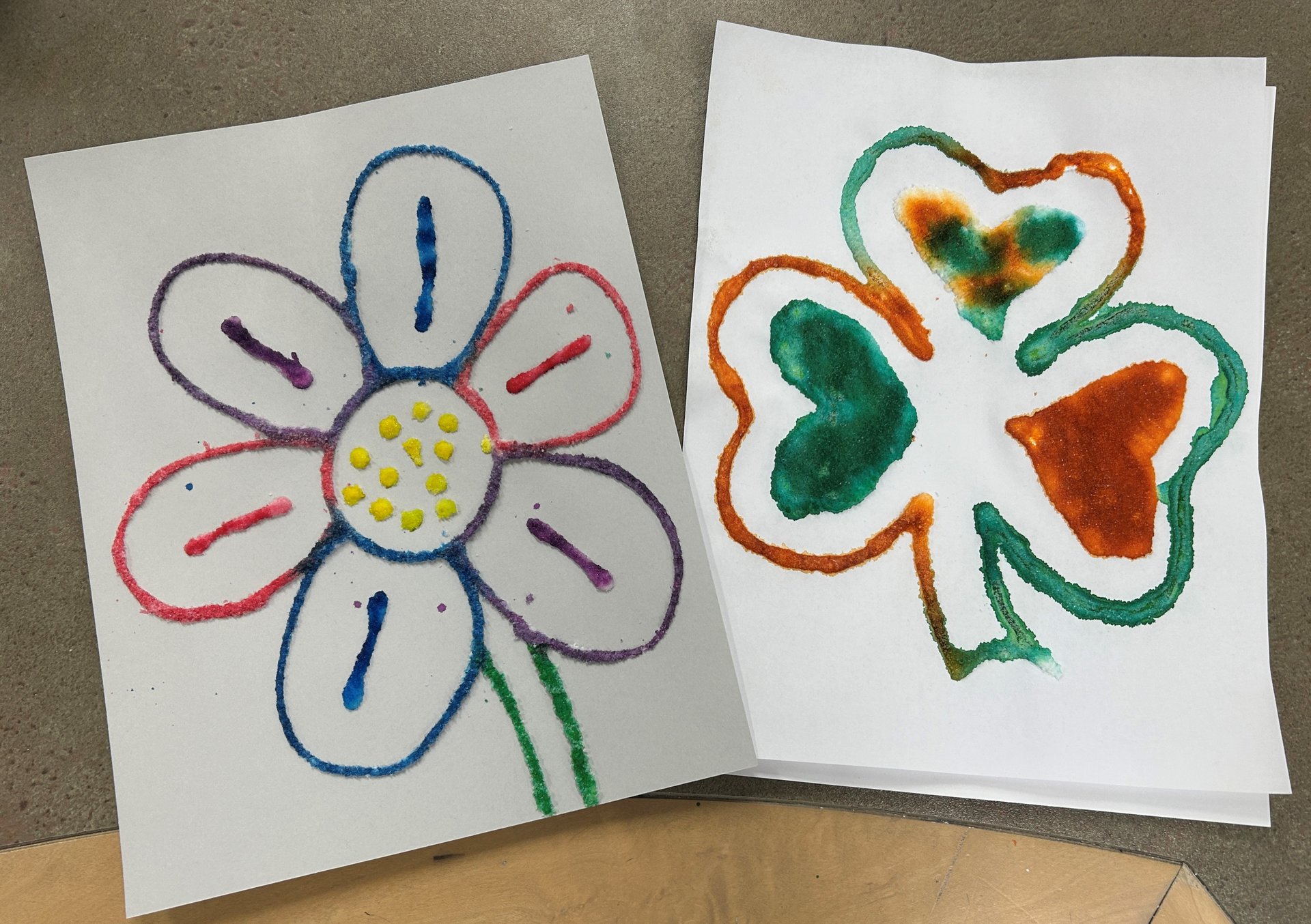 assortment colored flower and shamrock painted using salt and paint