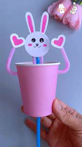Pink cup with paper bunny face and hearts for hands