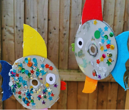 CD's decorated with colorful gems, large googly eyes and fins to look like a rainbow colored fish