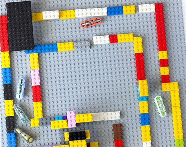 legos made into a maze with little robot bugs making their way thru the maze
