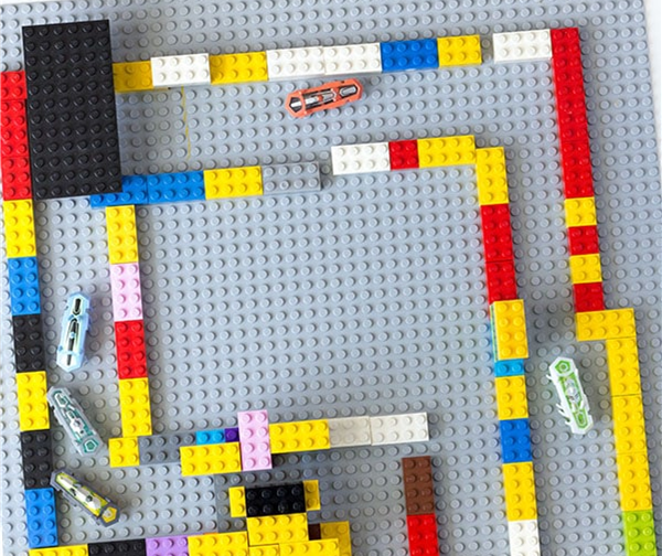 legos made into a maze with little robot bugs making their way thru the maze