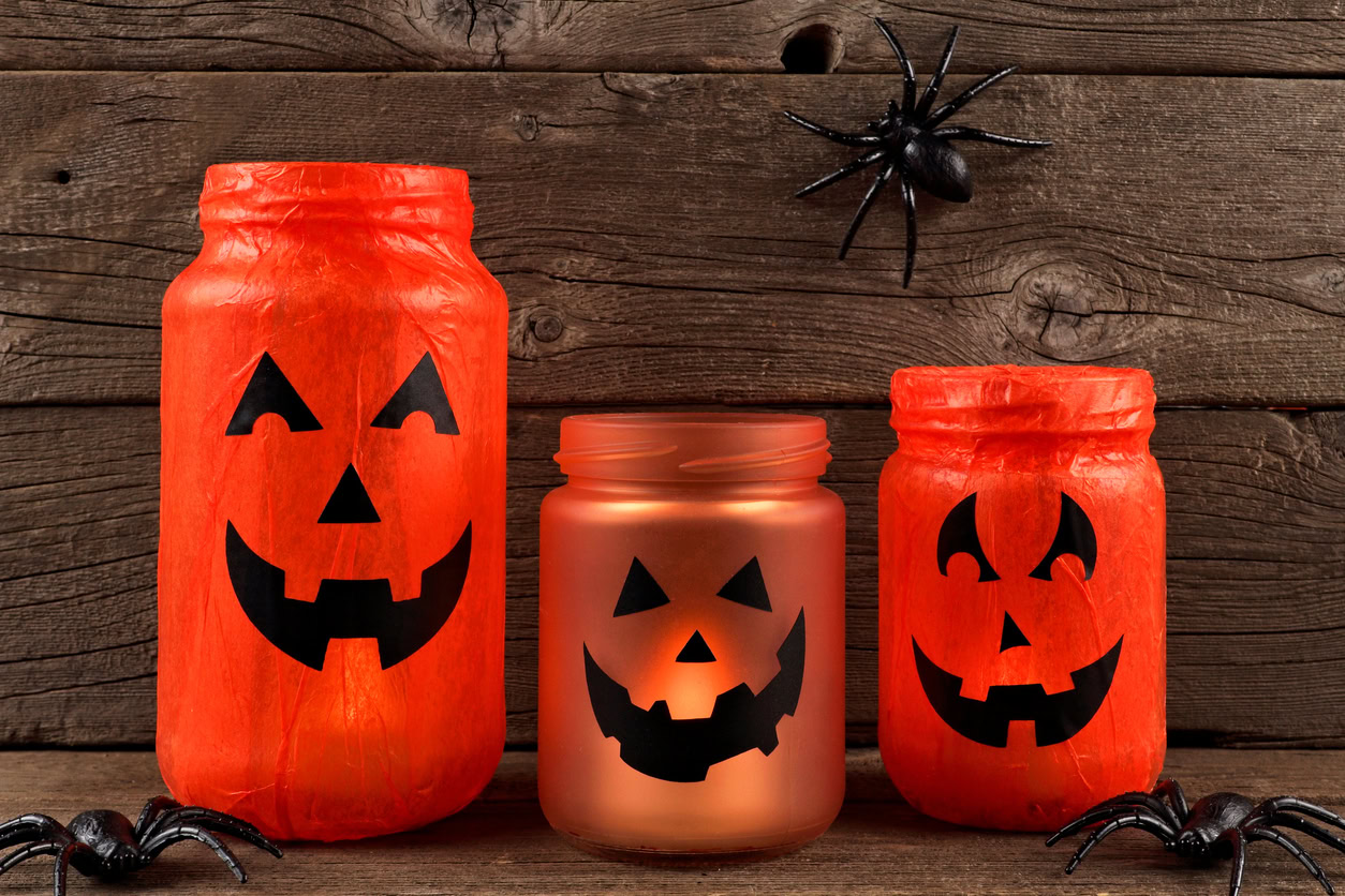 Mason jars painted to represent jack-o-lanterns