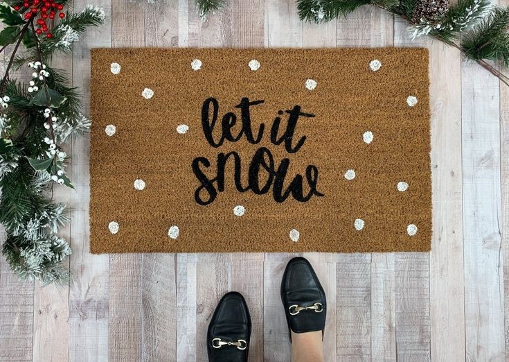 doormat with stenciled design that reads Let It Snow