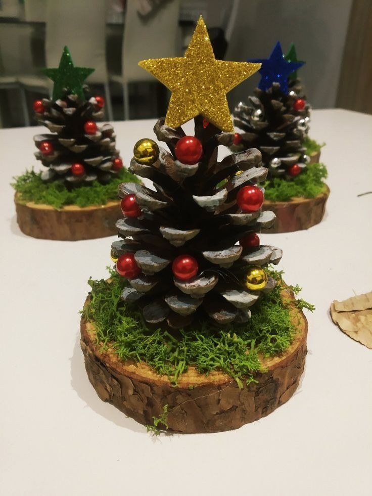 Christmas tree craft made using wood slice for base and pinecone for tree