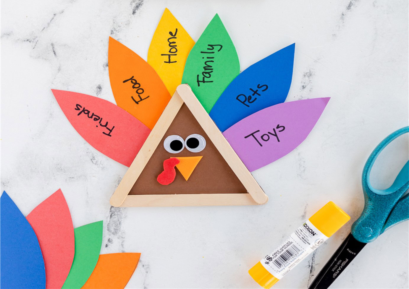 turkey craft made using craft sticks for the turkey body and colored paper for feathers