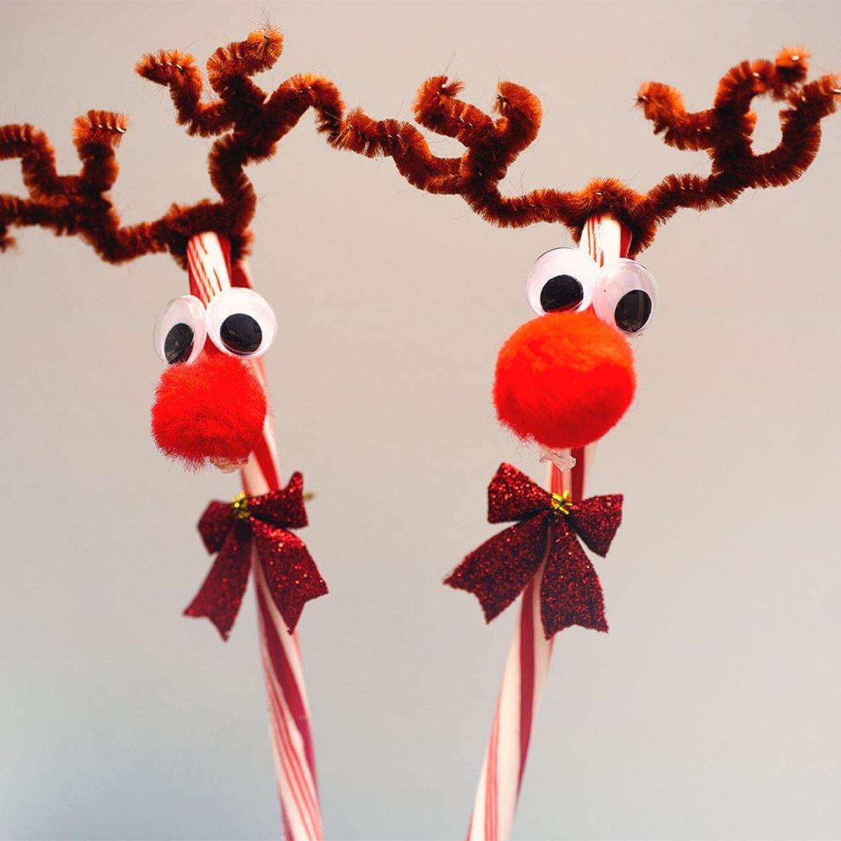 reindeer ornament made with a candy cane, pipe cleaners, pom pom and googly eyes