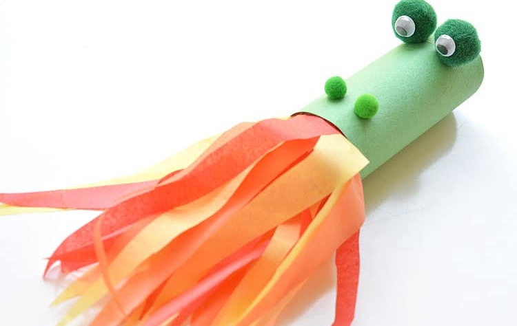 toilet paper tube painted green, craft pom pom balls glued on for eyes and nose, streamers coming out of the end to look like a dragon breathing fire