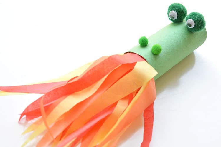 toilet paper tube painted green, craft pom pom balls glued on for eyes and nose, streamers coming out of the end to look like a dragon breathing fire