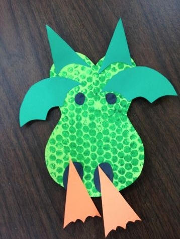 dragon face made out of construction paper and painted using bubble wrap to resemble scales