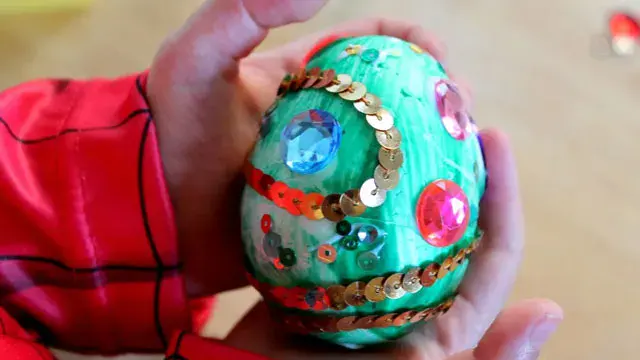 foam craft egg painted and decorated with sequins and craft gems