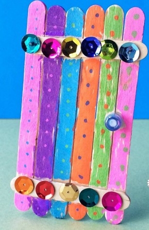 craft sticks painted and glued together to resemble a door and decorated with gems