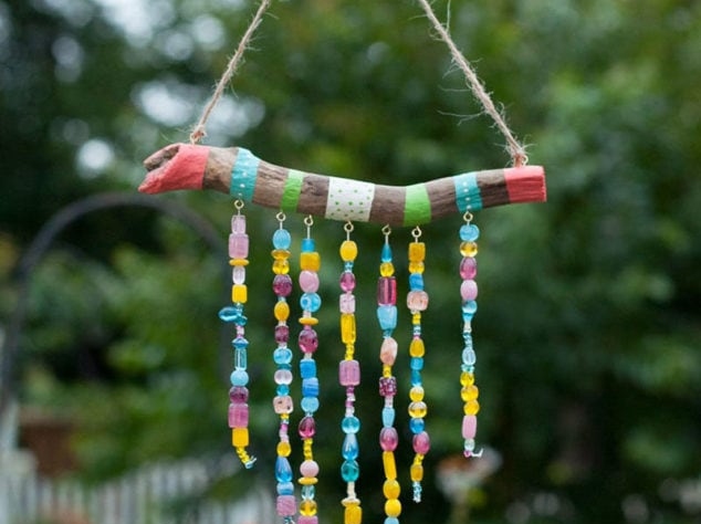 stick with pieces of yarn wrapped around it and hanging down with beads