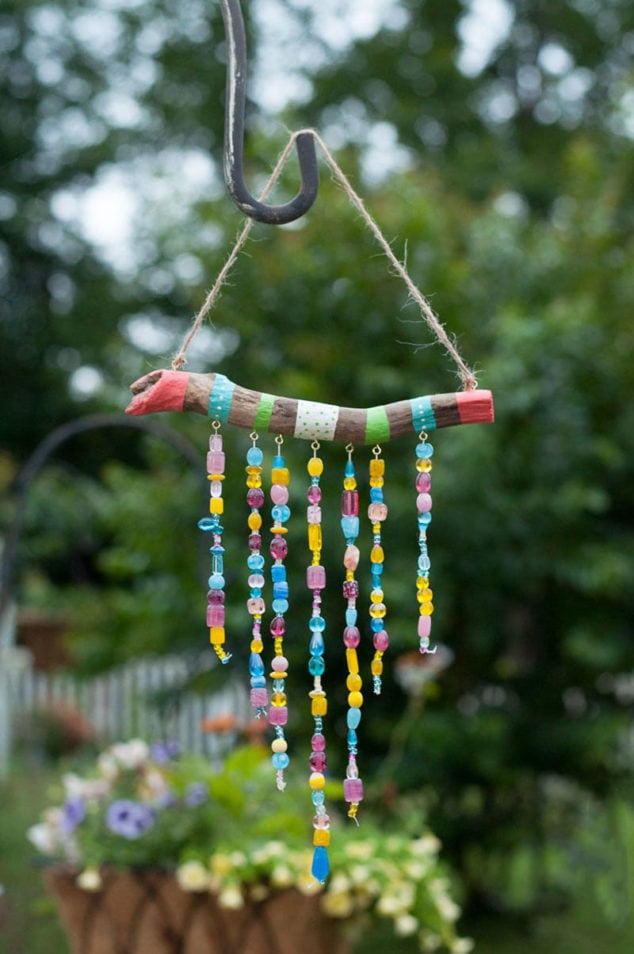 stick with pieces of yarn wrapped around it and hanging down with beads
