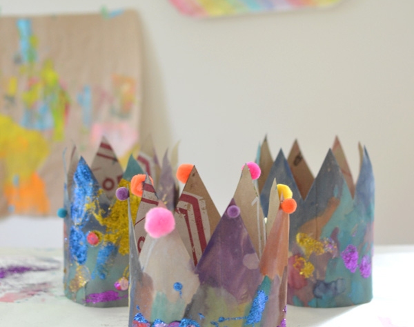 crown made from construction paper and decorated with paint, sequins and pom poms