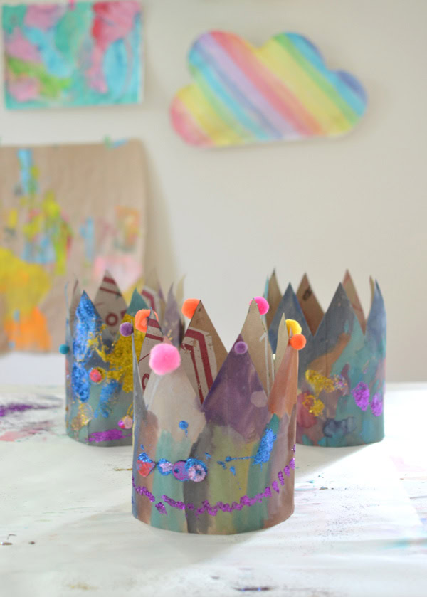 crown made from construction paper and decorated with paint, sequins and pom poms