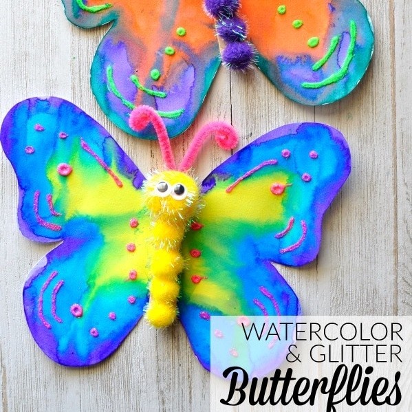 Paper butterfly decorated with watercolor paint and glitter