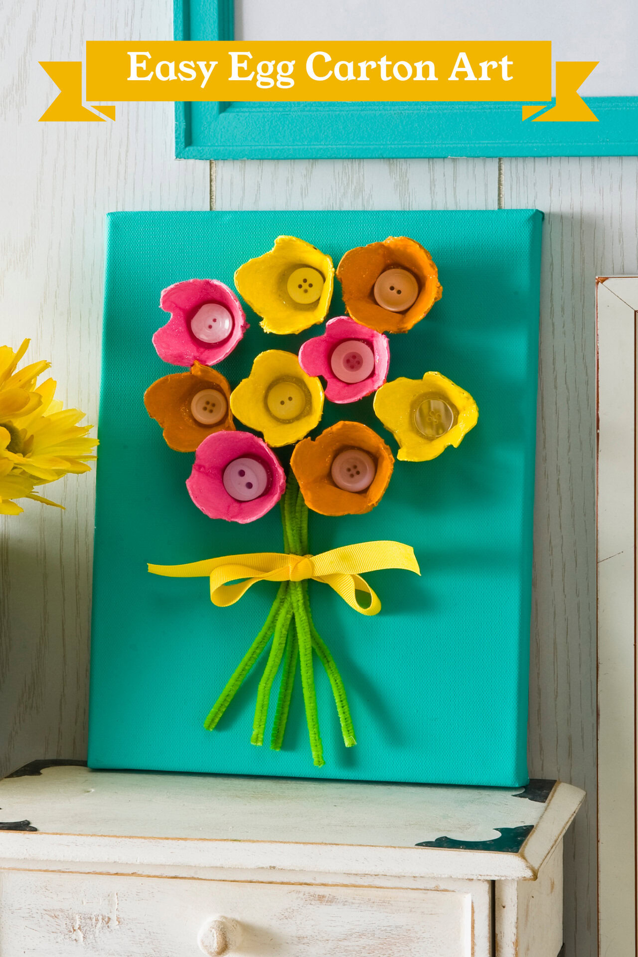 bouquet of flowers picture made using egg cartons for the flowers, a bow, and pipe cleaners for stems