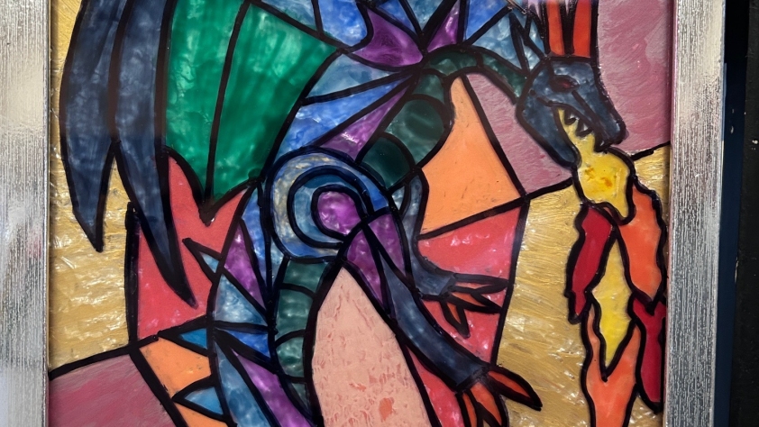 painted glass picture of a dragon in various colors