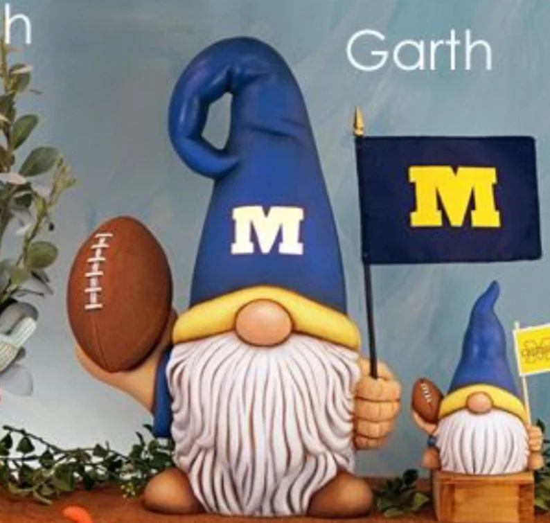 Ceramic gnome with blue hat holding a flag and a football