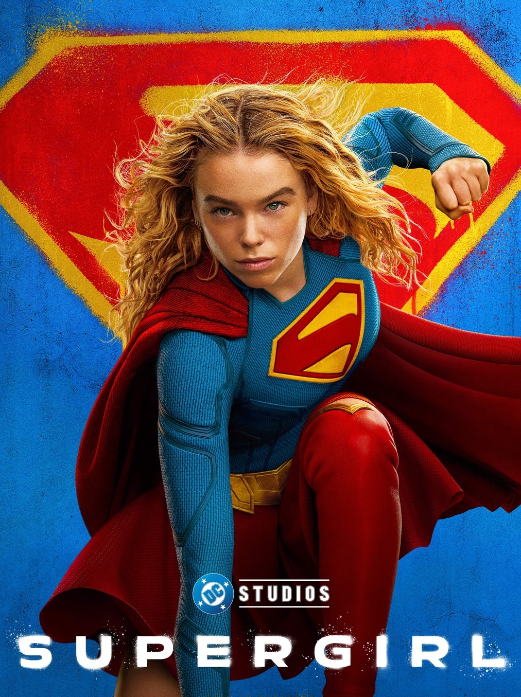 DC Supergirl movie poster with Supergirl in her suit on bended knee with Supergirl symbol in background