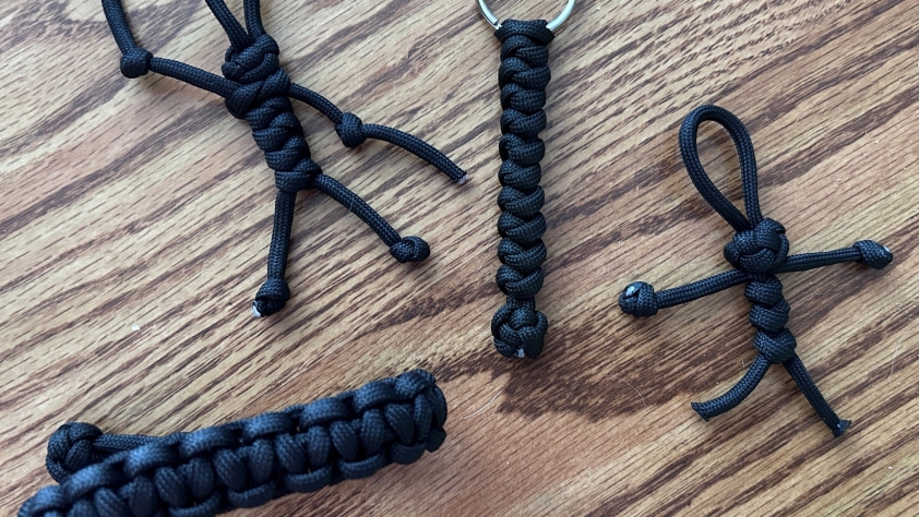 Various crafts made from black 550 paracord.