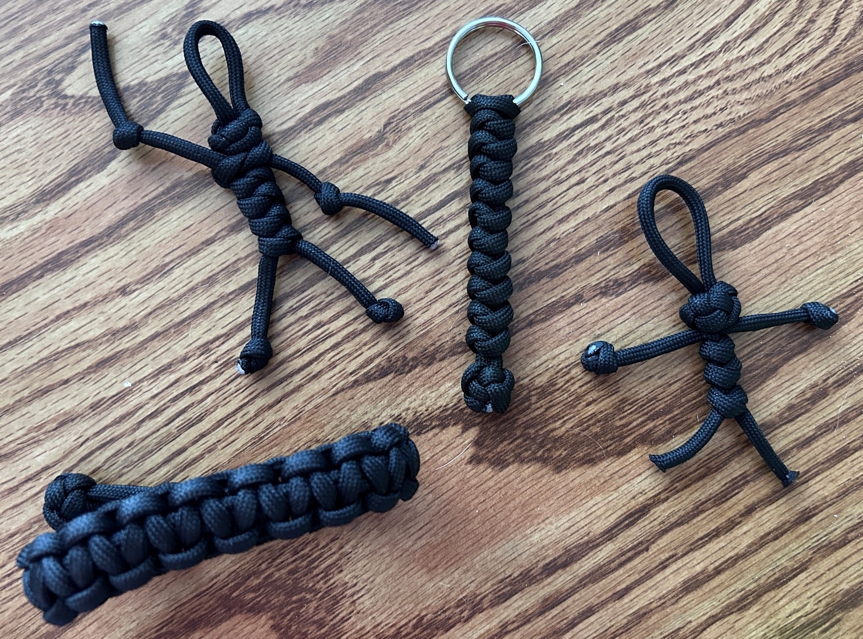 Various crafts made from black 550 paracord.