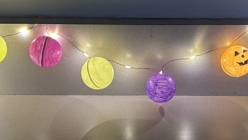 6 colored ping pong balls on string lights