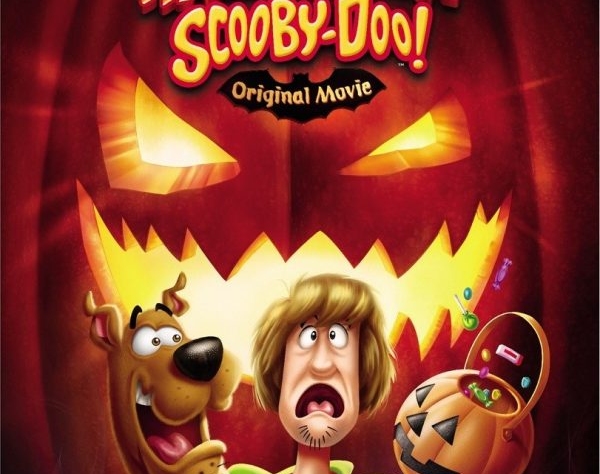animated scooby doo characters (scooby the dog and his human friend shaggy) looking scared in front of a large scary looking jack-o-lantern