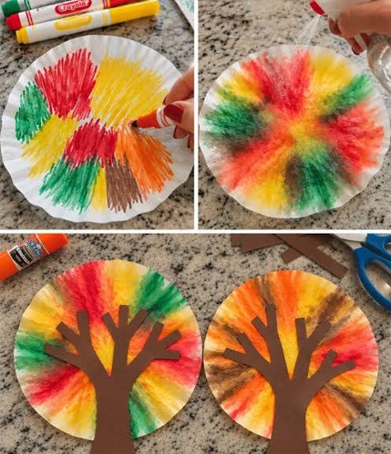 coffee filter colored with yellow, green and orange markers and a brown construction tree trunk
